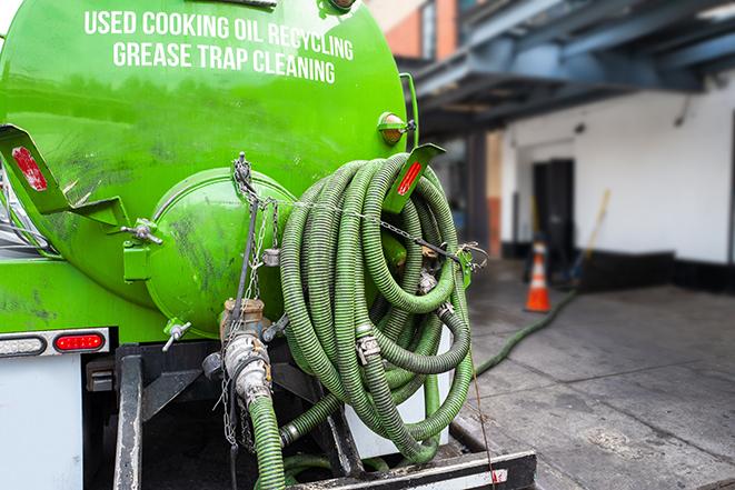 grease trap being pumped out by service technician in Atlantic City